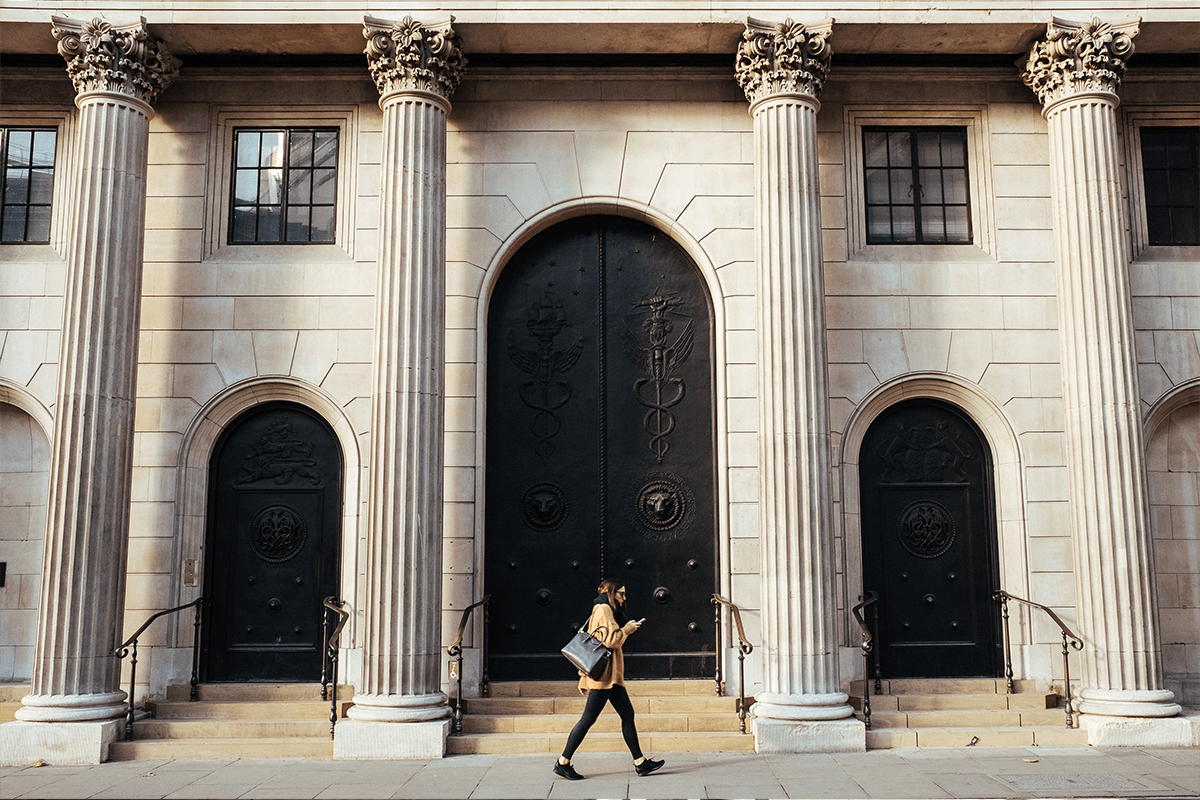 Woman walking past bank